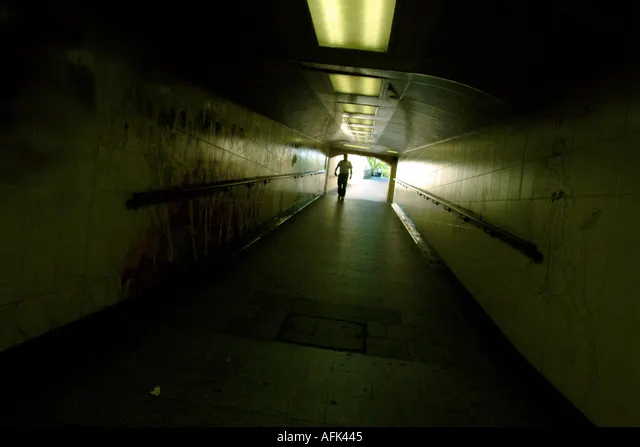 A figure at the end of an underpass tunnel, from 10 Feet