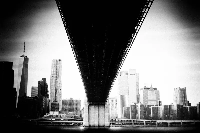 Underside of a bridge with the Lower Manhattan skyline, from Polyphony